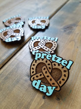 Load image into Gallery viewer, Pretzel Day Pin / Magnet with Hand Painted Lettering
